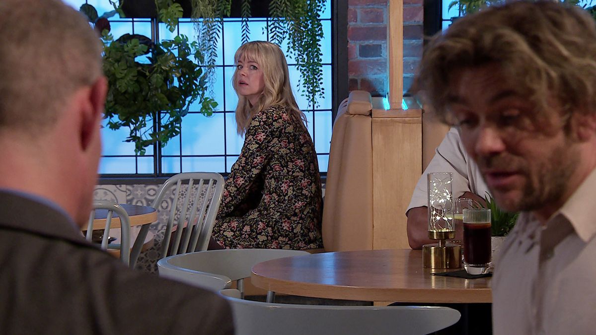 Toyah Battersby looks worried as she peers at Rowan and Nick across the Bistro.