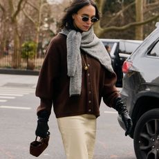 Woman in brown cardigan and gray sweater