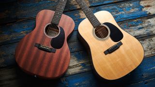 Two Martin guitars lying on a wooden floor