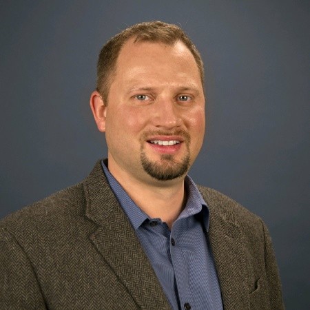 Smiling headshot of TJ Adams.