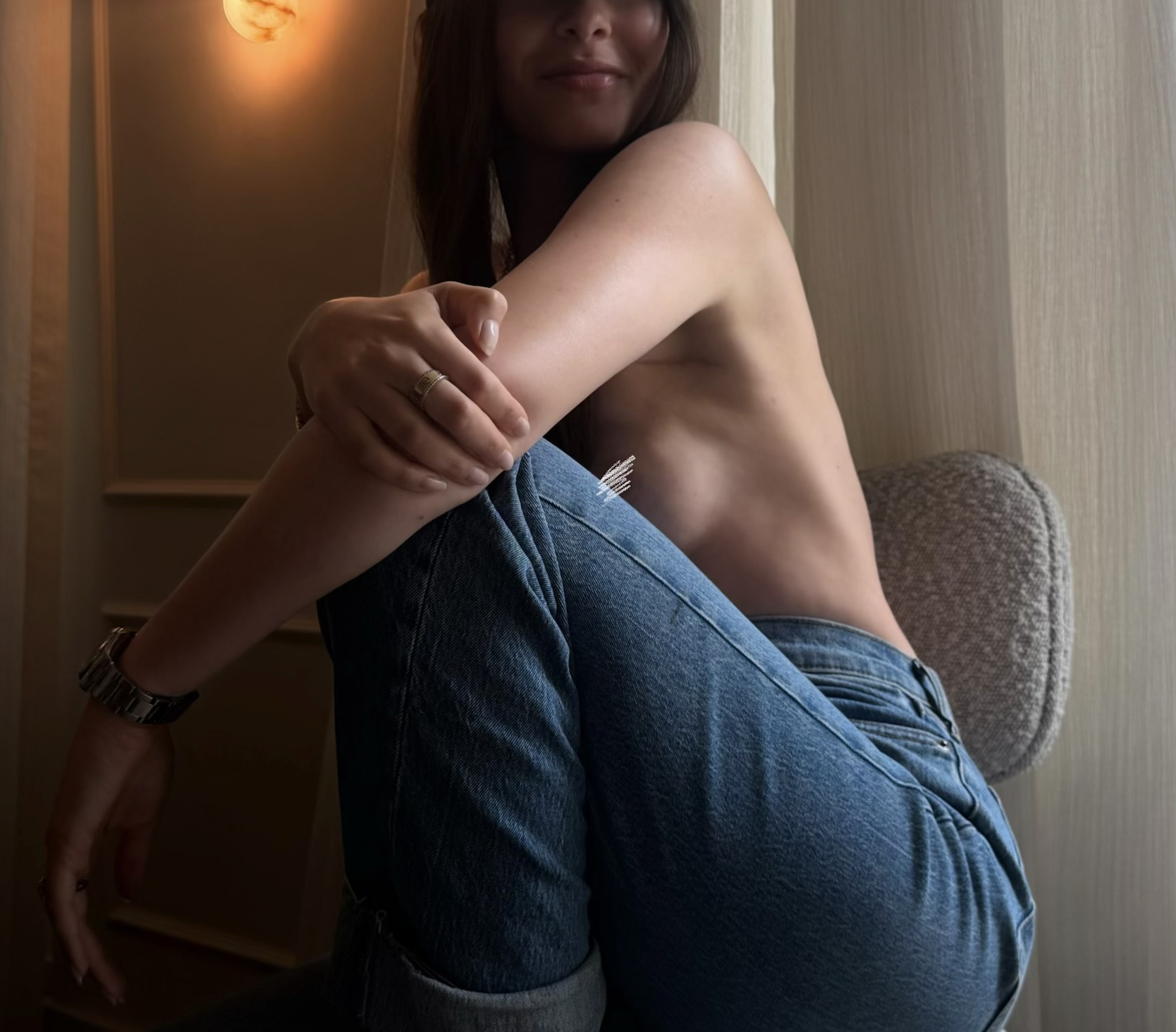 girl in jean and no top with her nipple blurred after a breast reconstruction
