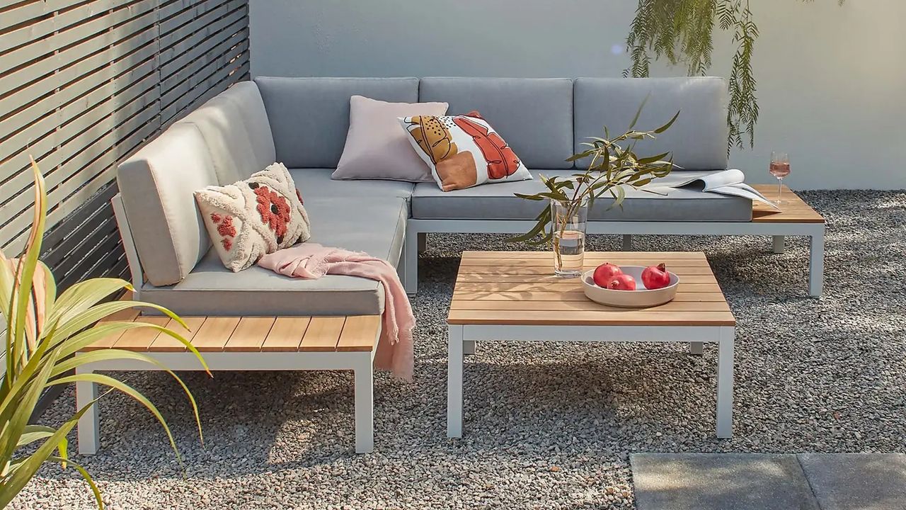 A modern aluminium outdoor sofa in a contemporary patio