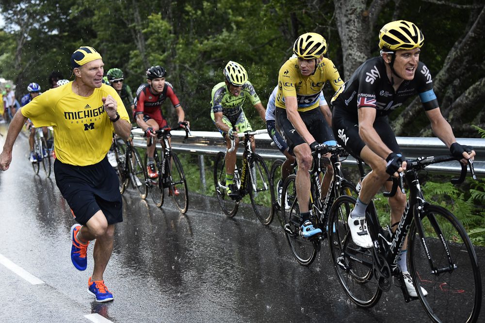 A spectator runs alongside Chris Froome during stage 12.