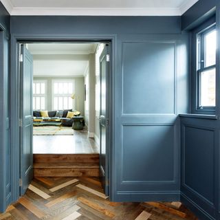 Hallway with blue panelled walls and doors