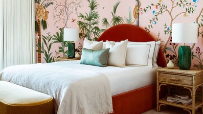 Best pillow: Bedroom with red bedstead and forest wallpaper