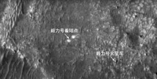 China's Tianwen 1 Mars orbiter captured this photo of NASA's Perseverance rover (bottom right) on the Red Planet's surface on March 7, 2022. The other arrow, in the center of the frame, points out Perseverance's landing area.