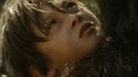 Max Records staring up at a large monster in Where the Wild Things Are