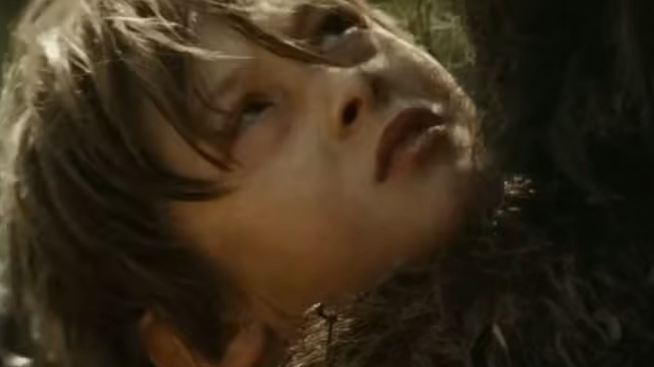 Max Records staring up at a large monster in Where the Wild Things Are