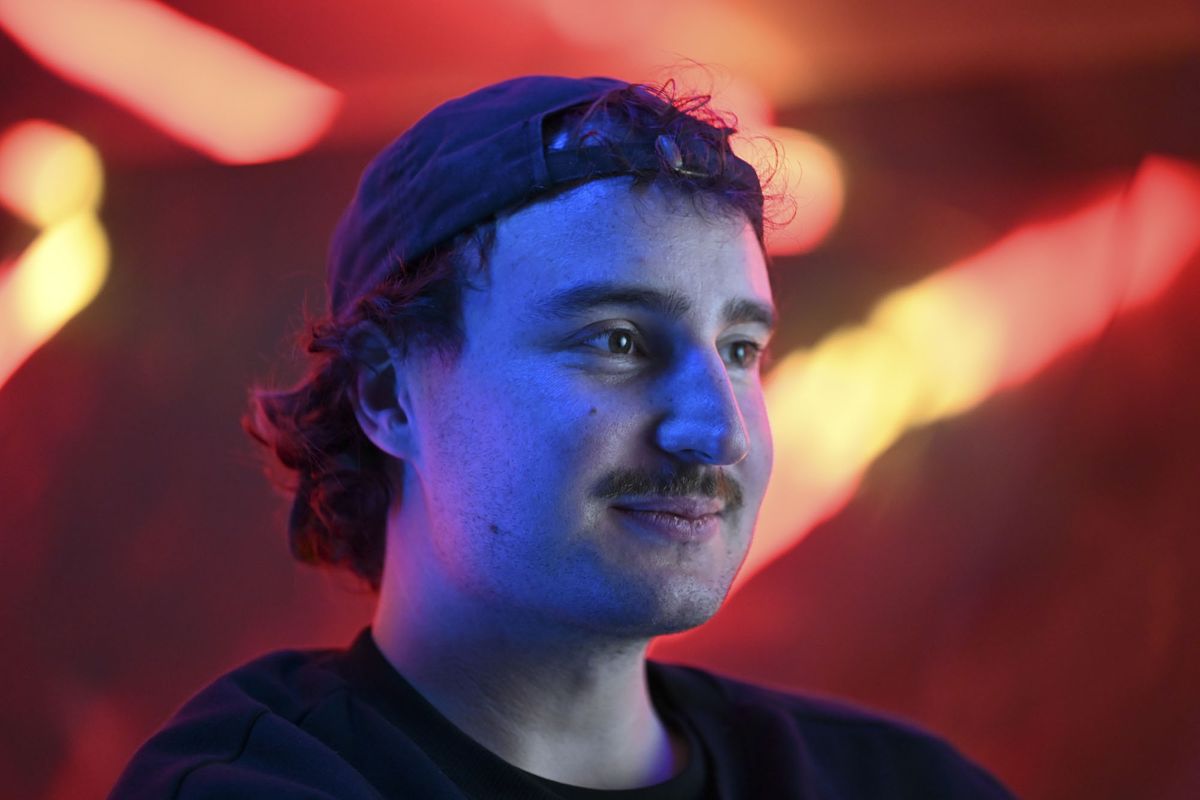 Nikon ZR sample images &ndash; man seated infront of neon lit wall
