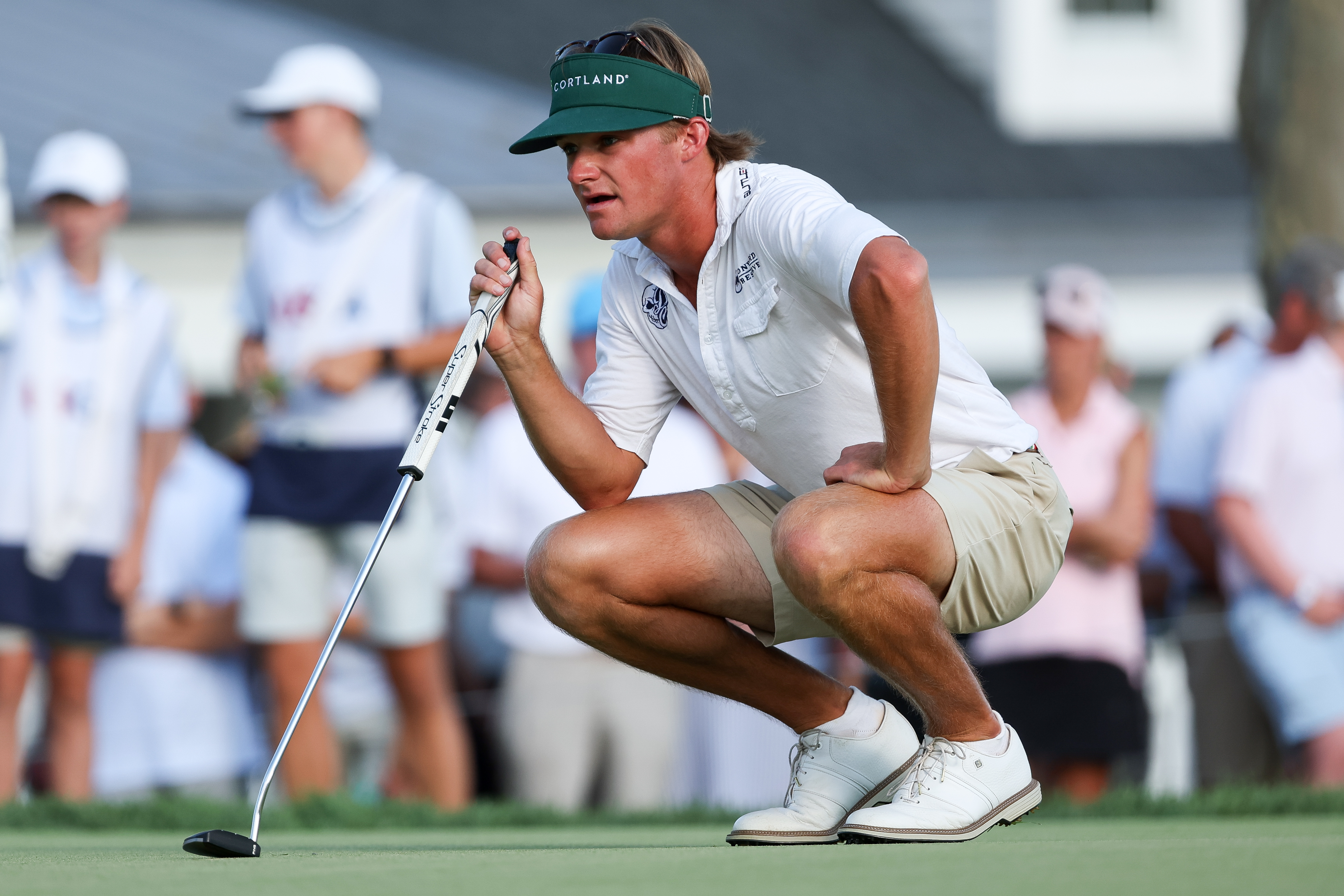 Carter Loflin crouches down behind a putt at the 2026 US Amateur