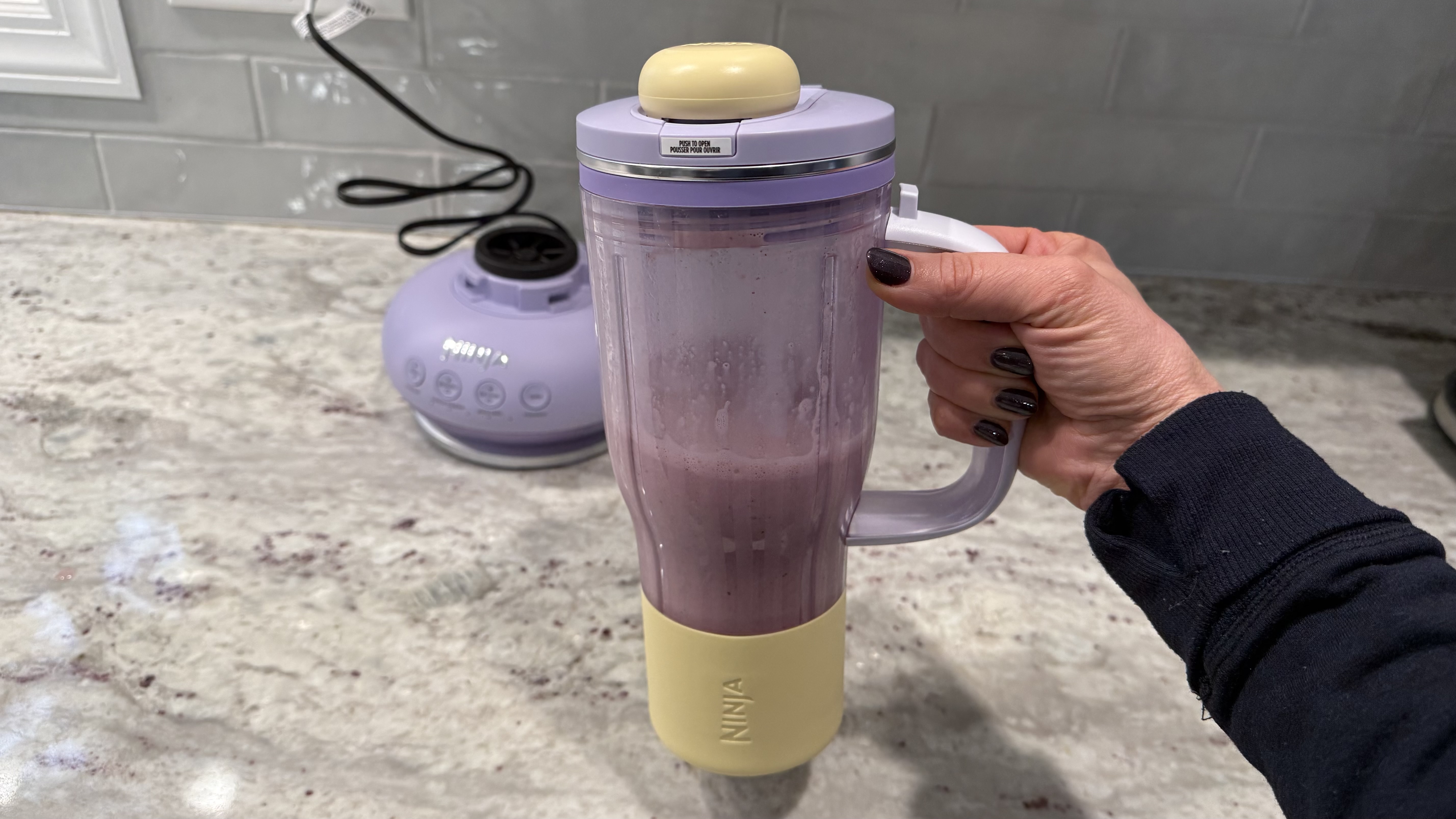 Ninja BlendBOSS&trade; Tumbler Blender with 26oz Travel Tumbler making a cherry smoothie