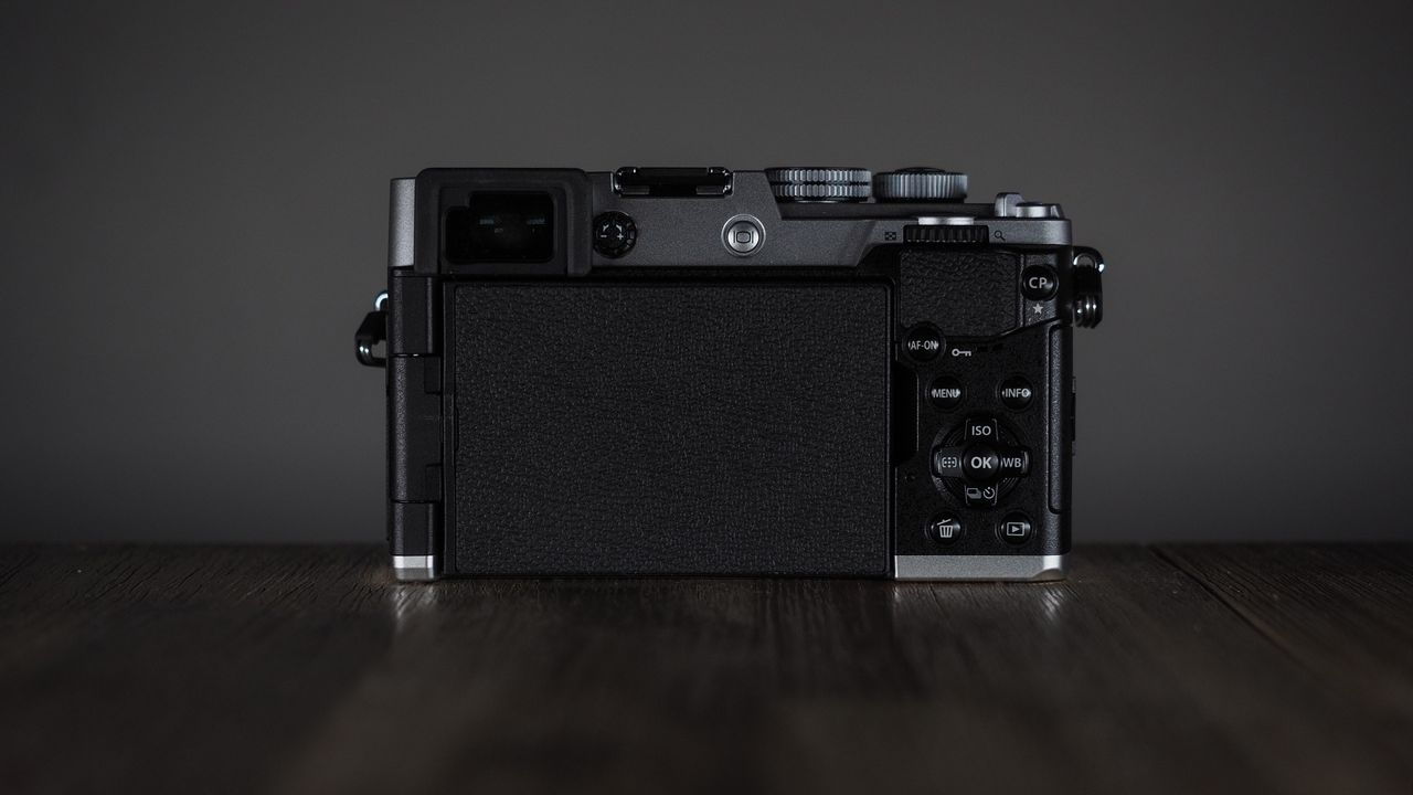 OM System OM-3 on a wooden surface