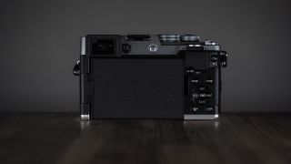 OM System OM-3 on a wooden surface