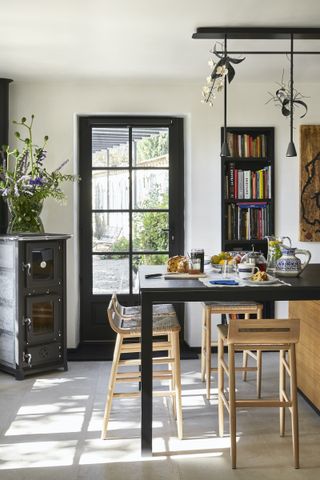 couuntry kitchen diner with black paintwork and kitchen island