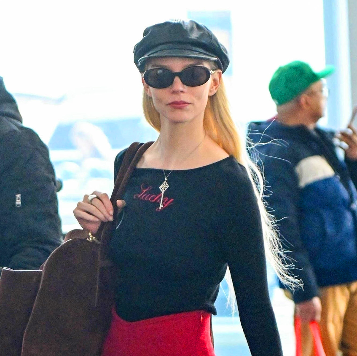 Anya Taylor-Joy wearing a newsboy cap at JFK