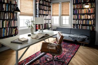 home office lined with books and mid century desk chair
