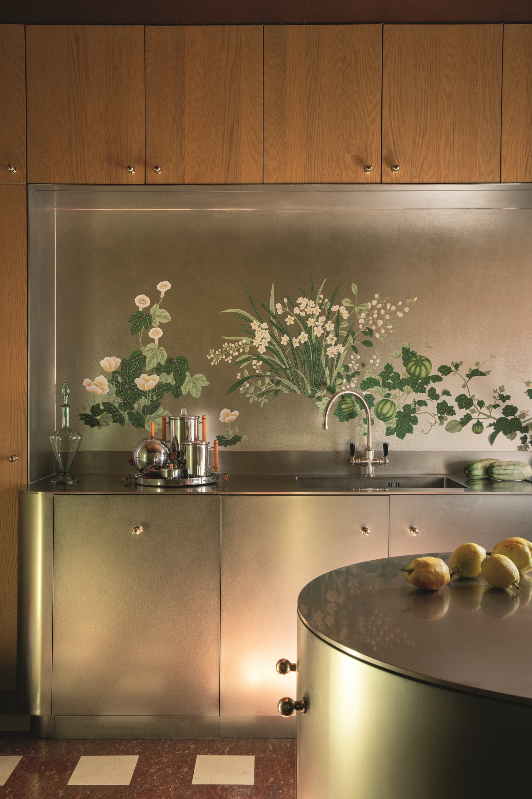modern kitchen with timber cabinets, stainless steel, metallic backsplash mural, silver decor, and curved island, with tiled floor