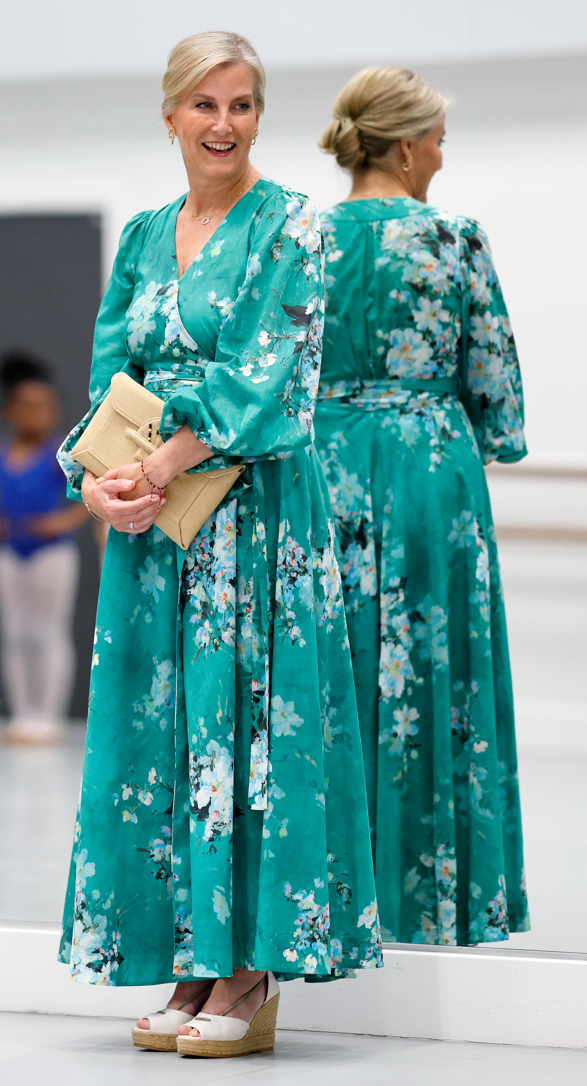 Duchess Sophie wearing a green floral maxi dress standing in front of a mirror