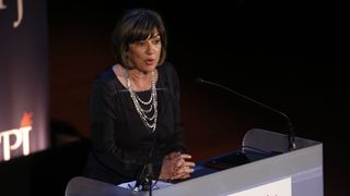 Christiane Amanpour speaks from behind a lectern.