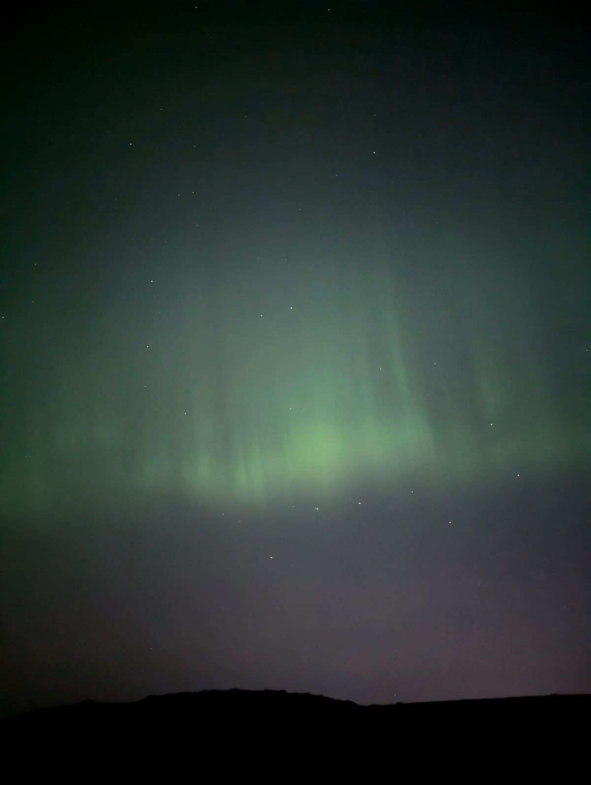 The Northern Lights' green pillars in the sky