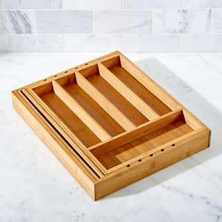 Bamboo flatware organizer on marble background