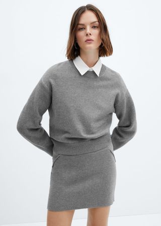 model wears gray sweater and gray skirt 