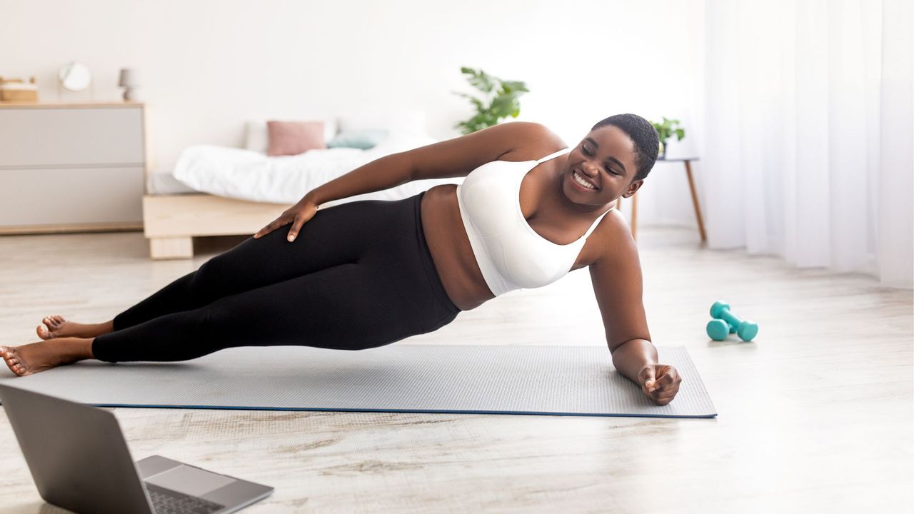 Best core workouts at home: A woman doing a side plank