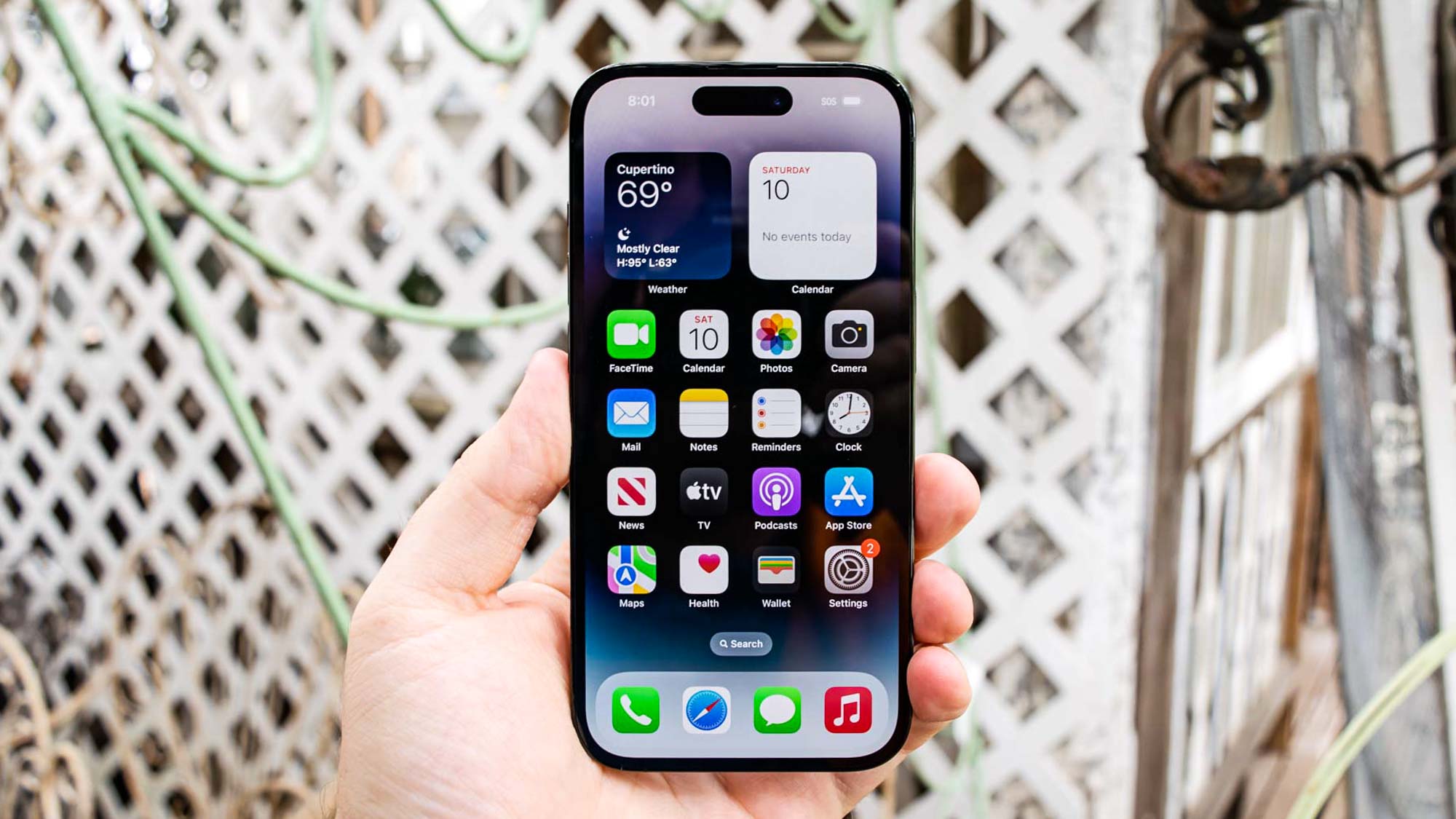 iPhone 14 Pro seen from the front with the iOS16 home screen