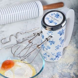 blue china rose hand mixer on worktop next to bowl with eggs