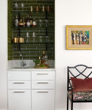 home bar in white cabinet with dark tiles