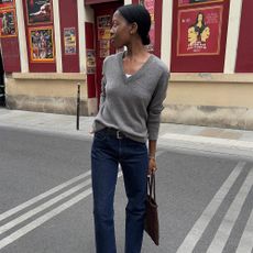 A french woman in a sweater and jeans