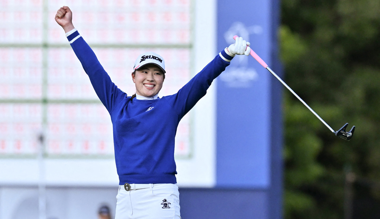 Rio Takeda celebrates after holing the winning putt on the green