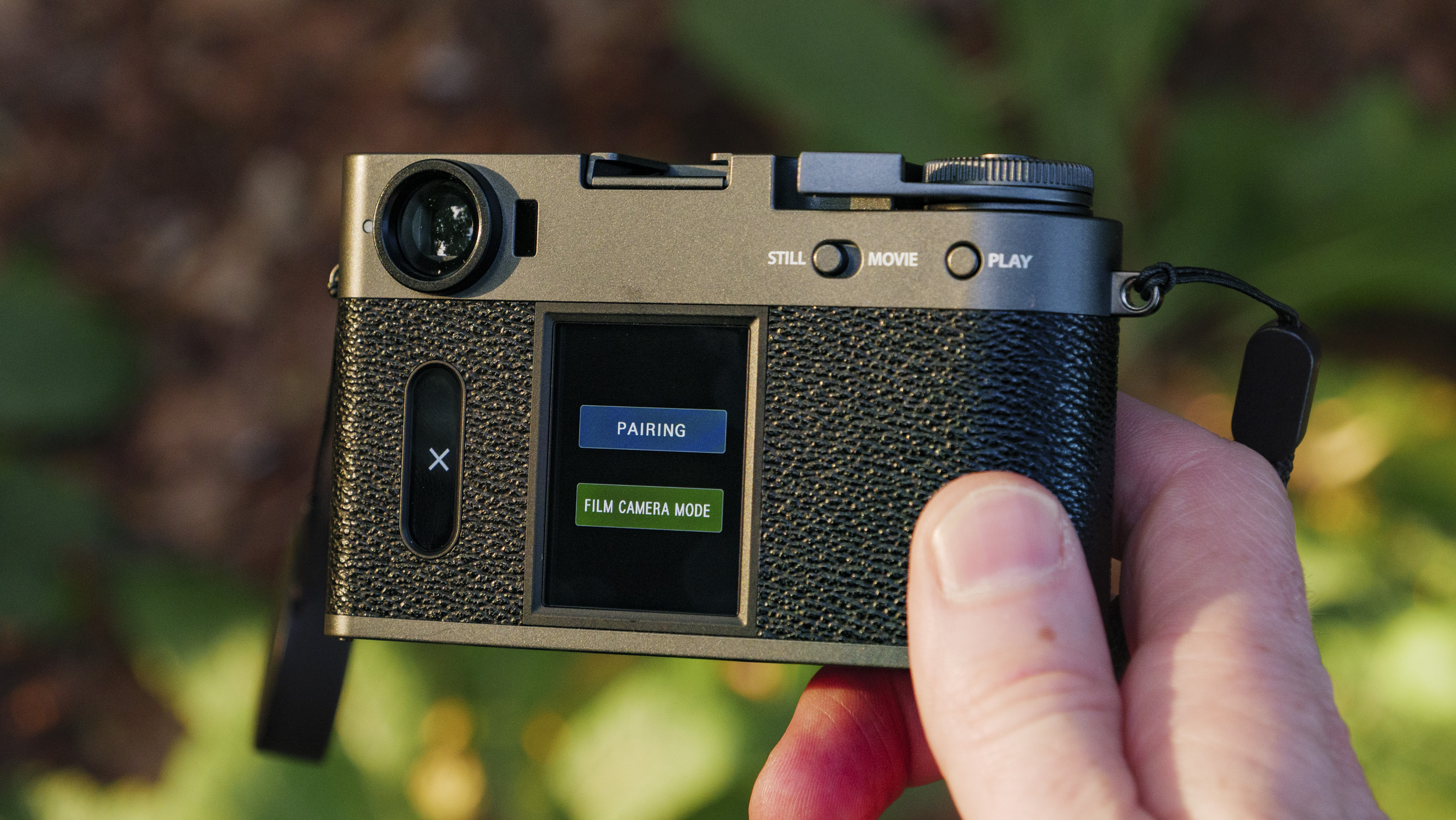 Fujifilm X half camera in the hand at golden hour