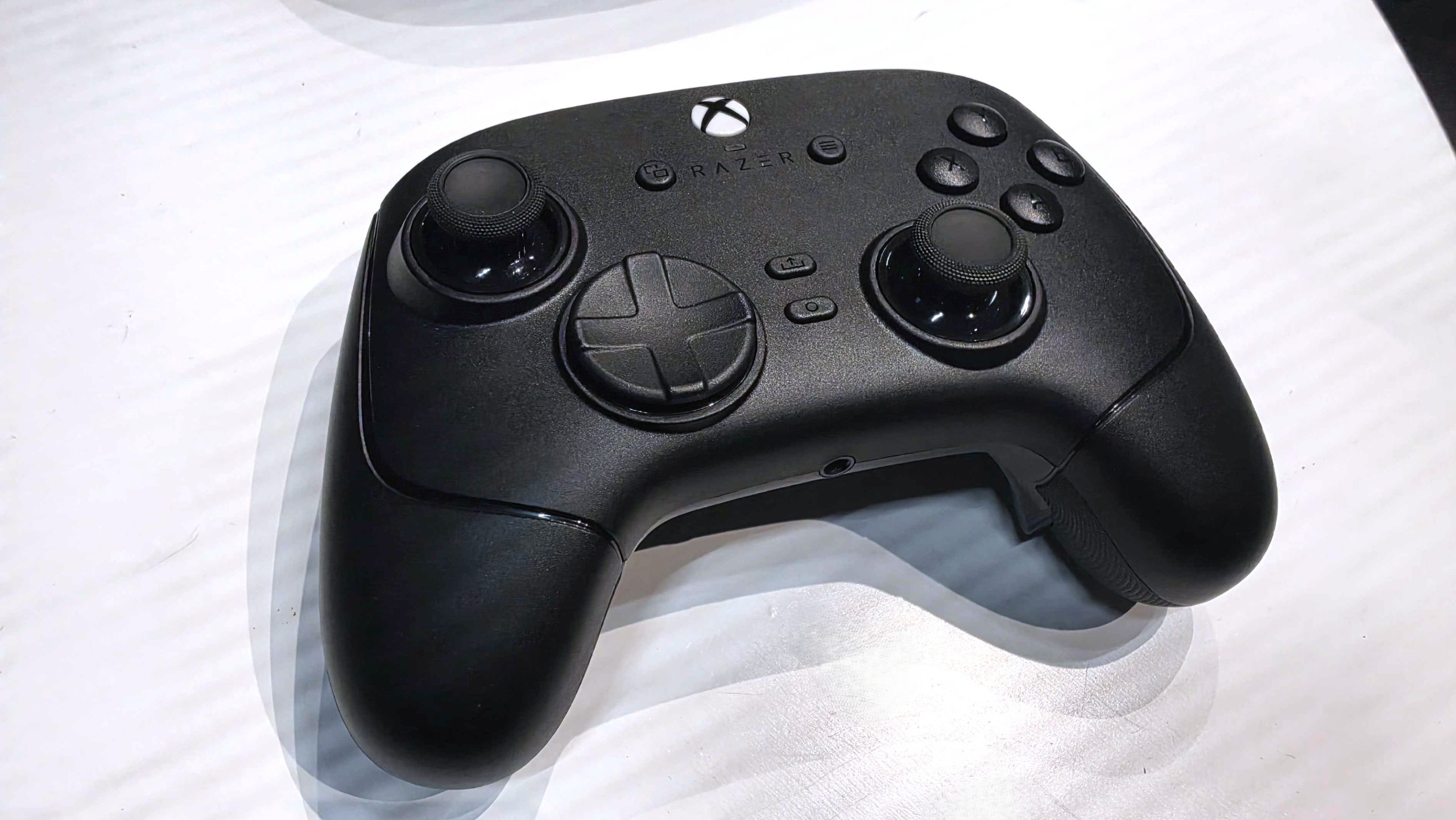 The Razer Wolverine V4 Pro Xbox controller sitting on a white table. 