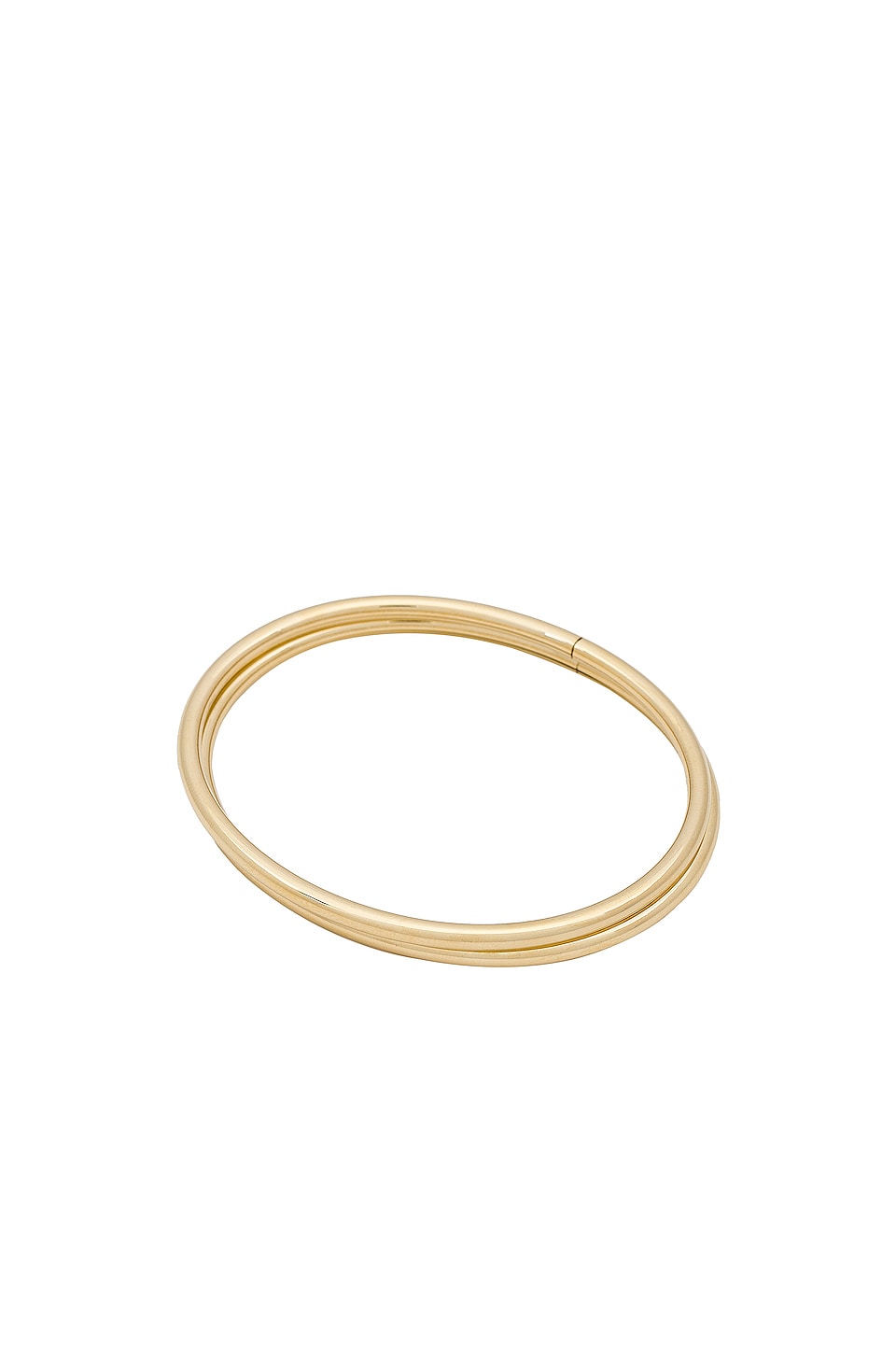 a gold bracelet by Jenny Bird in front of a plain backdrop