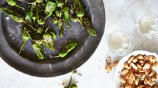 Padron peppers recipe, photographed on a black plate