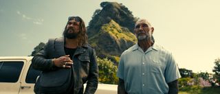 Jason Momoa and Dave Bautista stand by a car in The Wrecking Crew