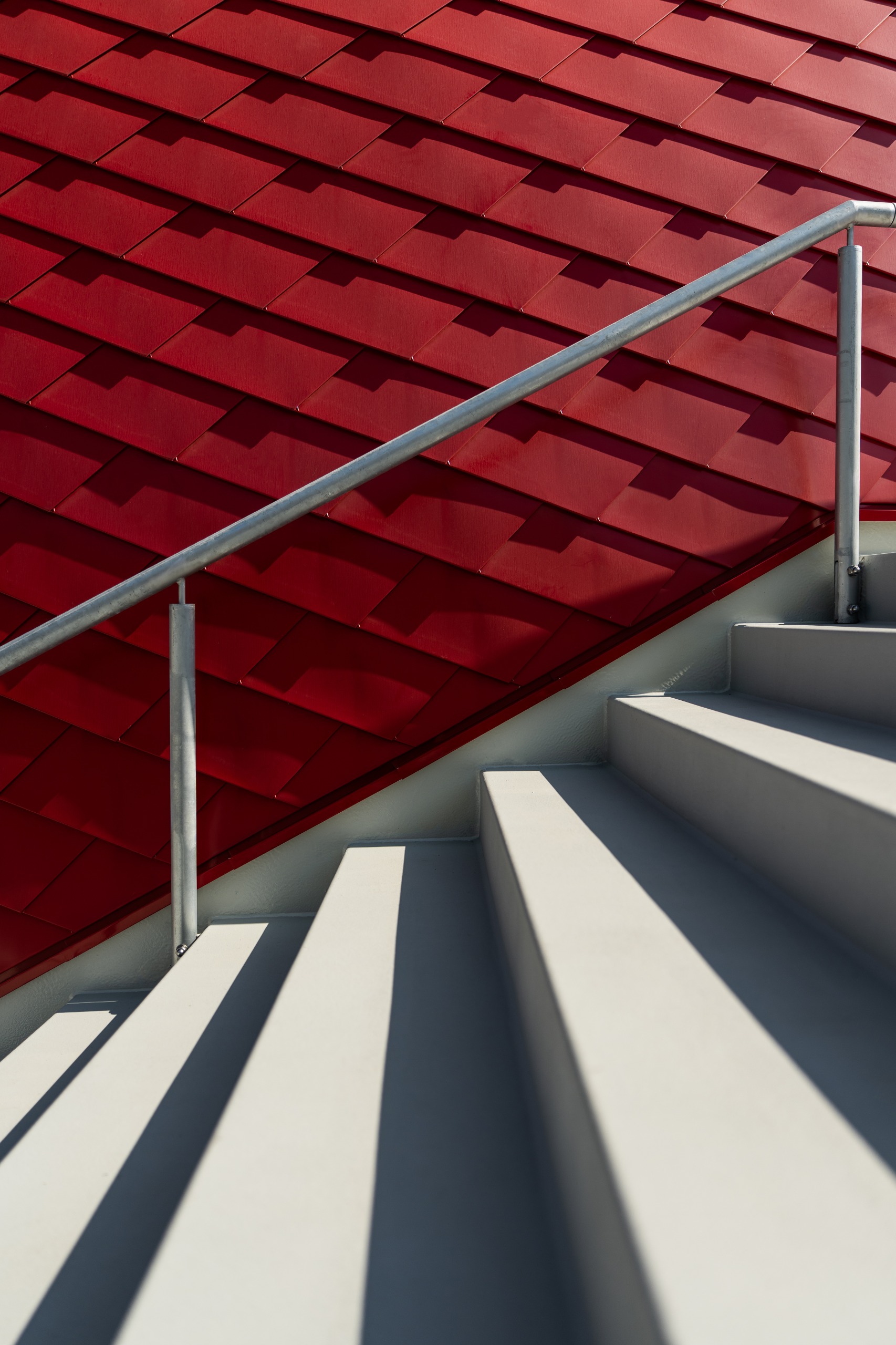 Architectural detail of stairs and red wall at Moto Guzzi museum and HQ at Mandello del Lario