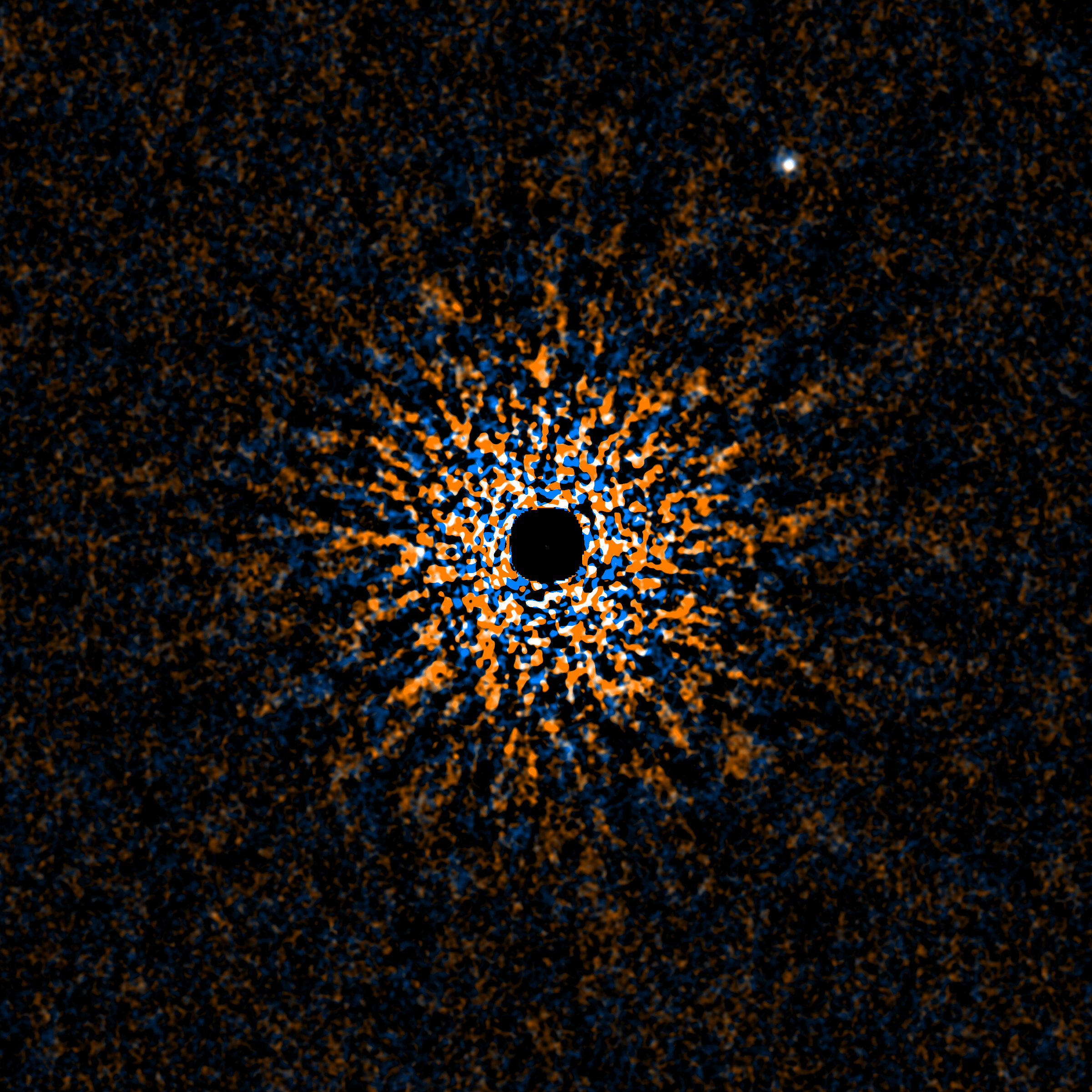 A black dot in the middle of a circle of blue, orange, and white smaller dots all on a black background