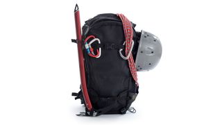 A black backpack loaded up with mountaineering equipment
