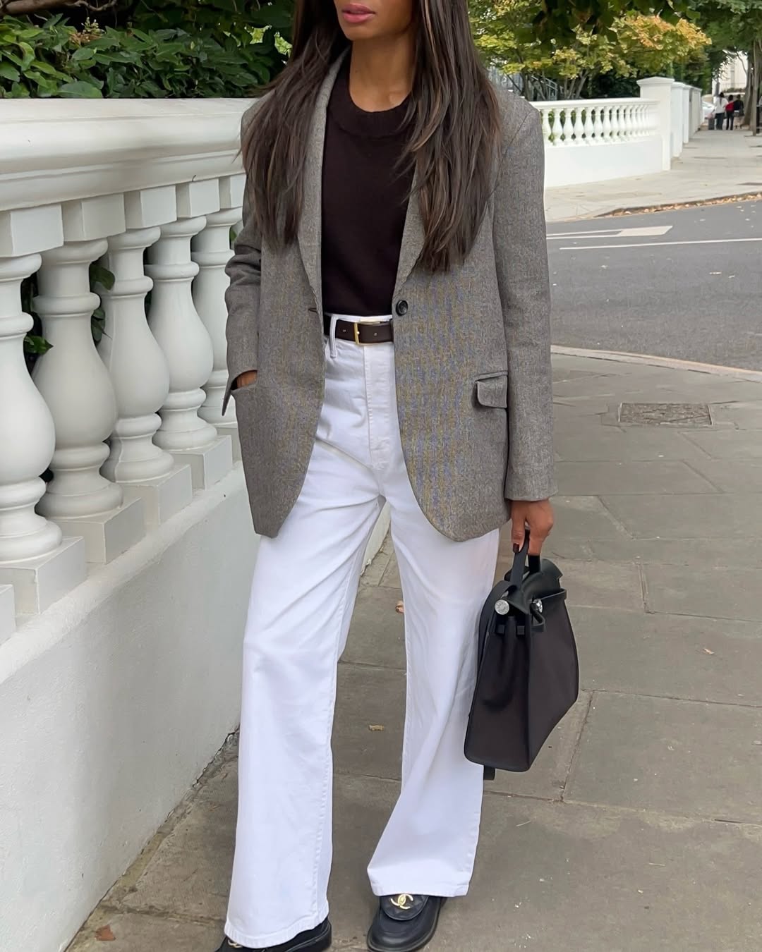 Lorna in grey blazer, white jeans and black loafers