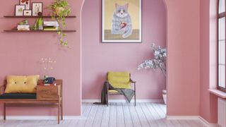 pink hallway and living room with grey wooden flooring