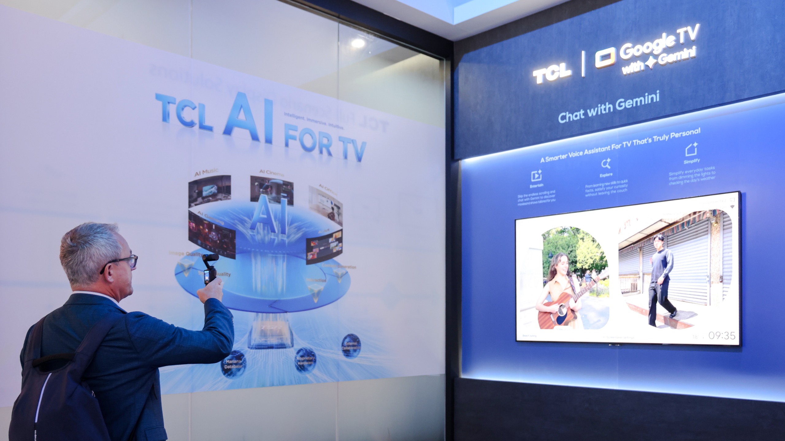 TCL's booth at IFA 2026 where a man takes video of a demonstration of AI in TVs