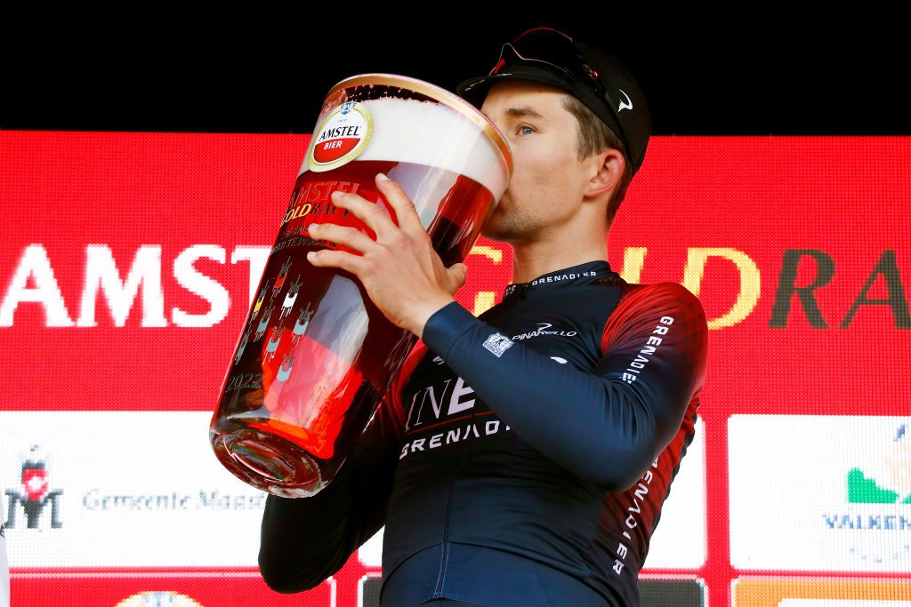 VALKENBURG NETHERLANDS APRIL 10 Michal Kwiatkowski of Poland and Team INEOS Grenadiers drinks beer to celebrates winning the race on the podium ceremony after the 56th Amstel Gold Race 2022 Mens Elite a 2541km one day race from Maastricht to Valkenburg AGR2022 WorldTour on April 10 2022 in Valkenburg Netherlands Photo by Bas CzerwinskiGetty Images