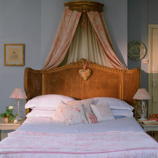 bedroom with blue wall wooden with white designed cushion lamps