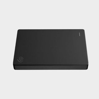 Black Seagate portable drive on a grey background