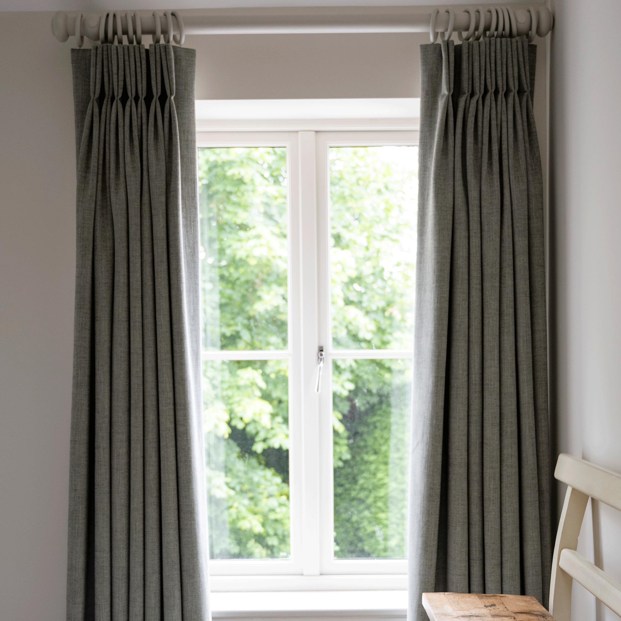 Grey curtains in front of a window