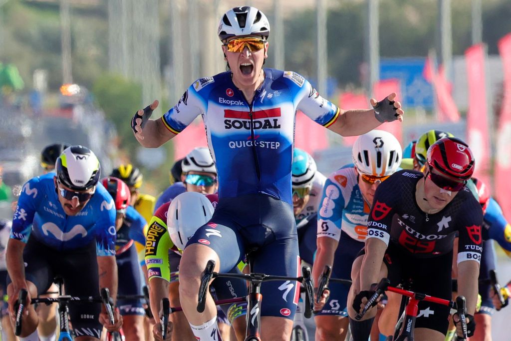 Belgium&#039;s Tim Merlier (C) of Soudal Quick-Step celebrates as he crosses the finish line to win stage 1 of the 6th UAE Tour 2024, from Al Dhafra Walk to Liwa, on February 19, 2024. (Photo by Giuseppe CACACE / AFP)