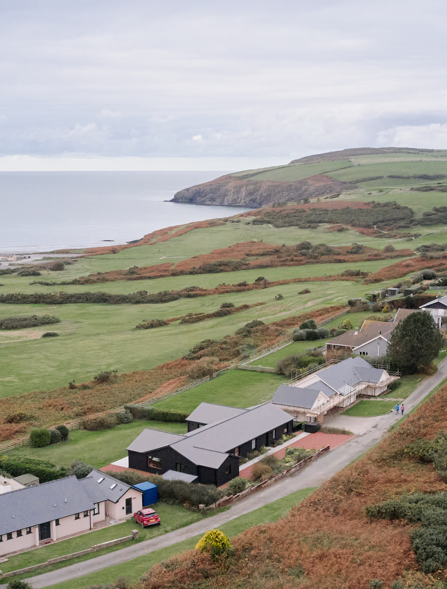 view of a welsh cottage or bungalow type building facing the sea and redesigned in a fairly minimalist, contemporary way