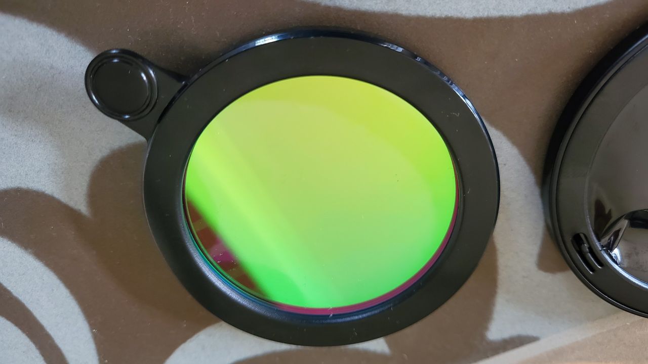 The Vaonis light pollution filter for the Vaonis Vespera Observation Station. It's a green circle with a black outline
